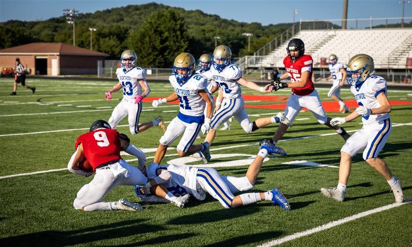 A football player is tackled